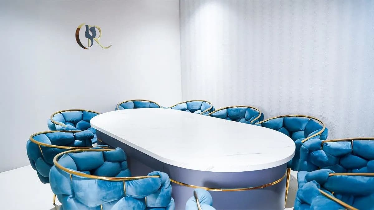 Patient counseling room with oval conference table, blue velvet chairs, and audio-video recording facilities for transparency