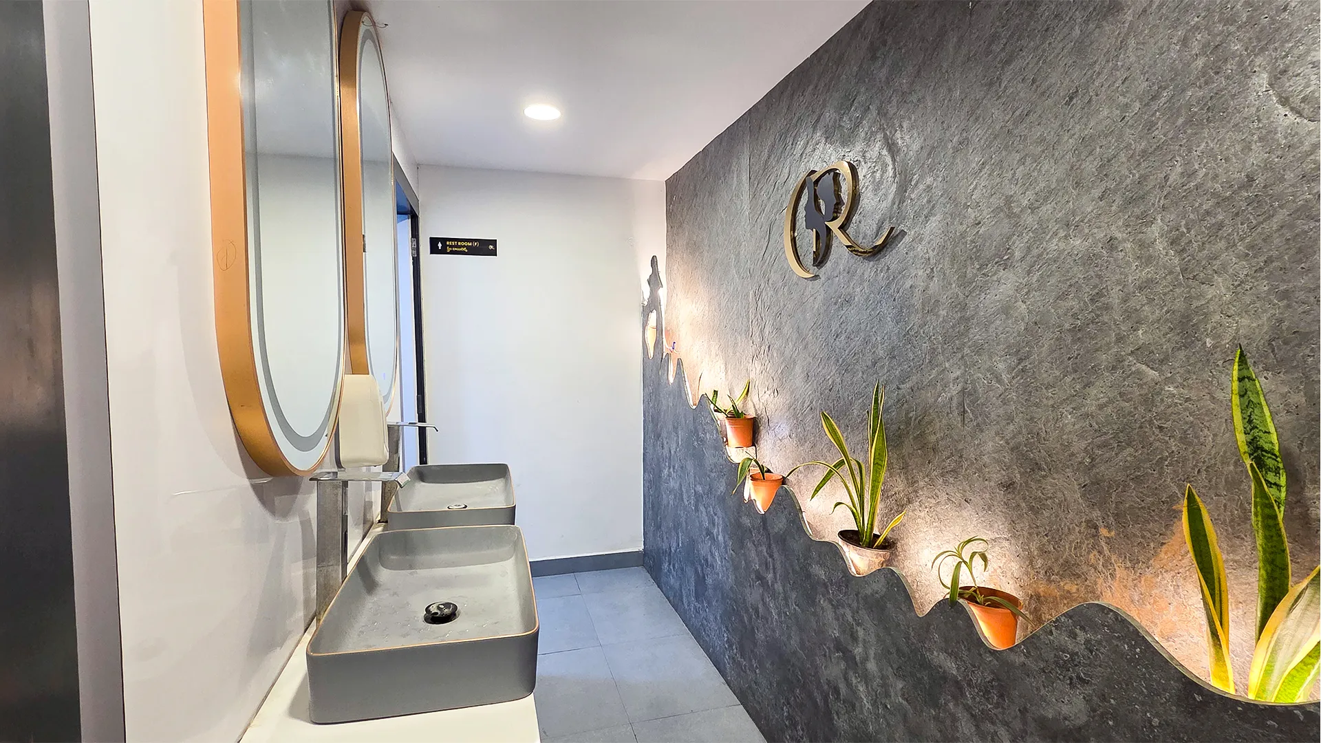 Touch-free Sensor Taps in Gender-Neutral Washroom with Premium Stone Finish